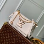 {Style No: UC5LFYYU} TWIST SLIM 19 IN LIGHT PINK TAURILLON CALFSKIN GOLD HARDWARE