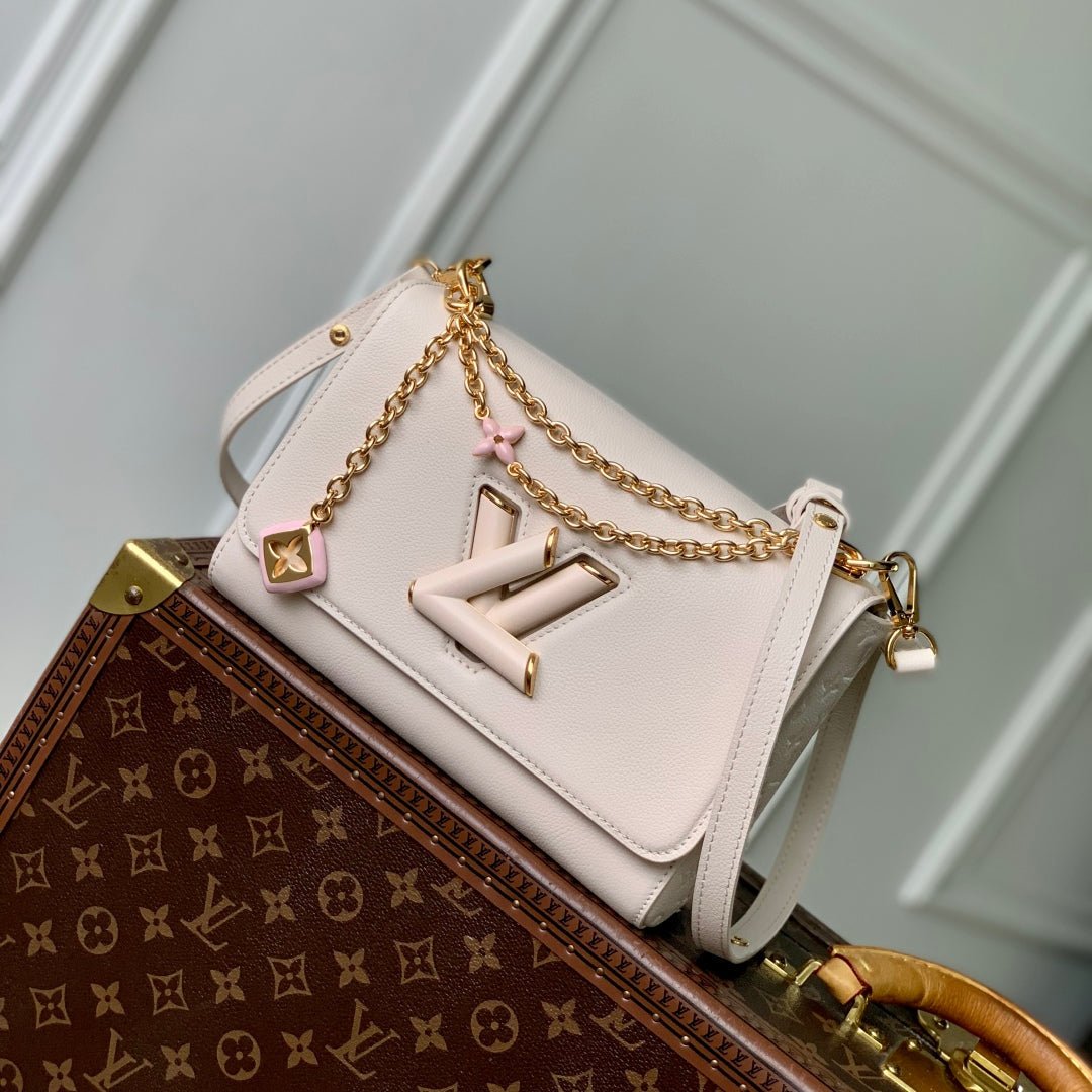 {Style No: UC5LFYYU} TWIST SLIM 19 IN LIGHT PINK TAURILLON CALFSKIN GOLD HARDWARE
