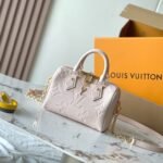 {Style No: UY53LRNH} SPEEDY BANDOULIÈRE 20 IN LIGHT PINK MONOGRAM EMPREINTE LEATHER