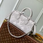 {Style No: QXRJ1YTZ} ONTHEGO EAST WEST BAG 25 IN BICOLOR MONOGRAM EMPREINTE LEATHER
