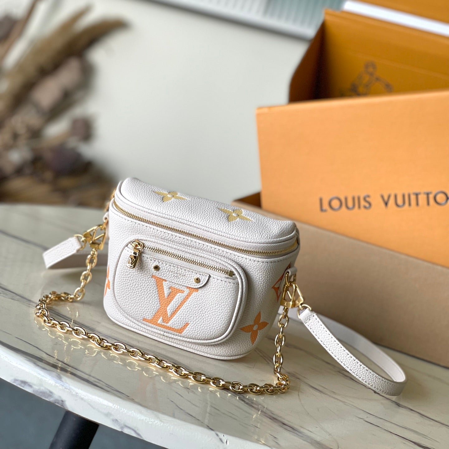 {Style No: J11NDO9O} MINI BUMBAG 17 IN WHITE ORANGE MONOGRAM EMPREINTE LEATHER GOLD HARDWARE